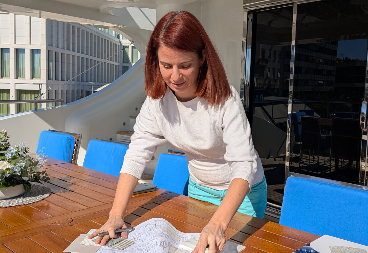 An architect shaping space during spatial planning - working on an interior design in natural light, on the deck of a yacht