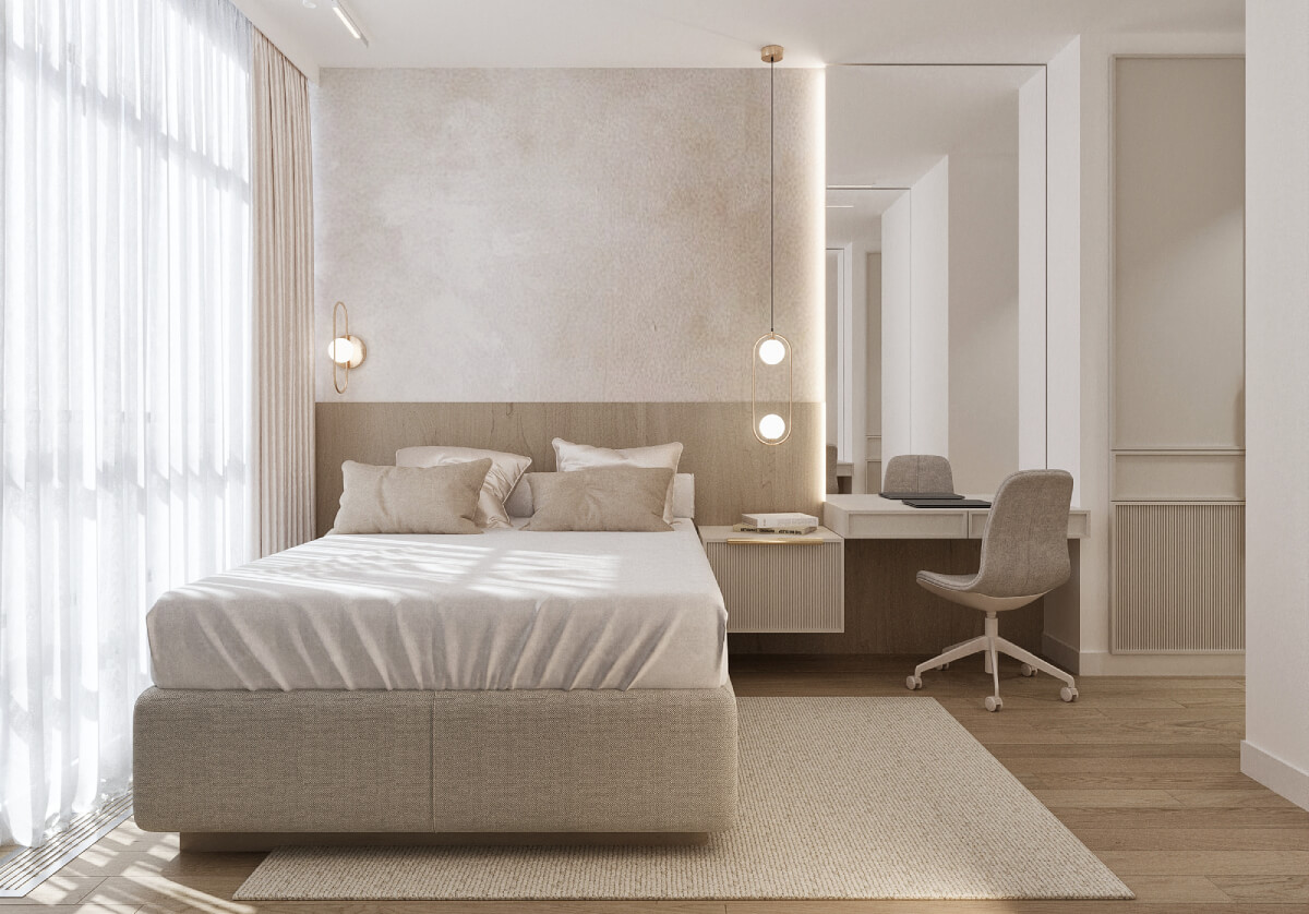 Minimalist bedroom with upholstered bed, textured wall finish and integrated desk workspace in soft neutral tones.