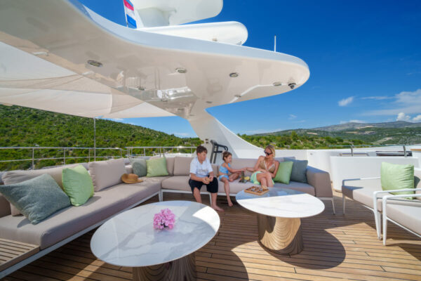 Relaxation area on the sunny deck of the Silent World yacht with the family outdoors