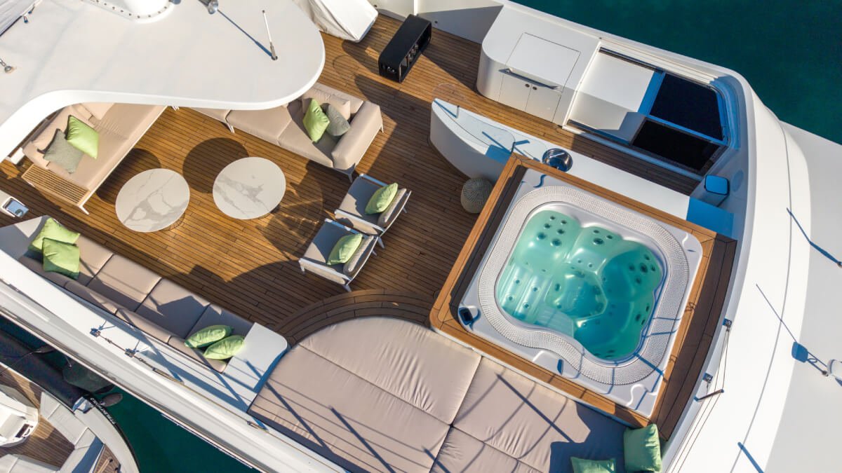 Aerial view of the Silent World yacht sundeck with a jacuzzi and outdoor lounge area