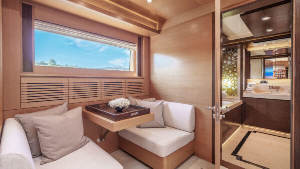 Silent World yacht cabin seating area with attached private bathroom