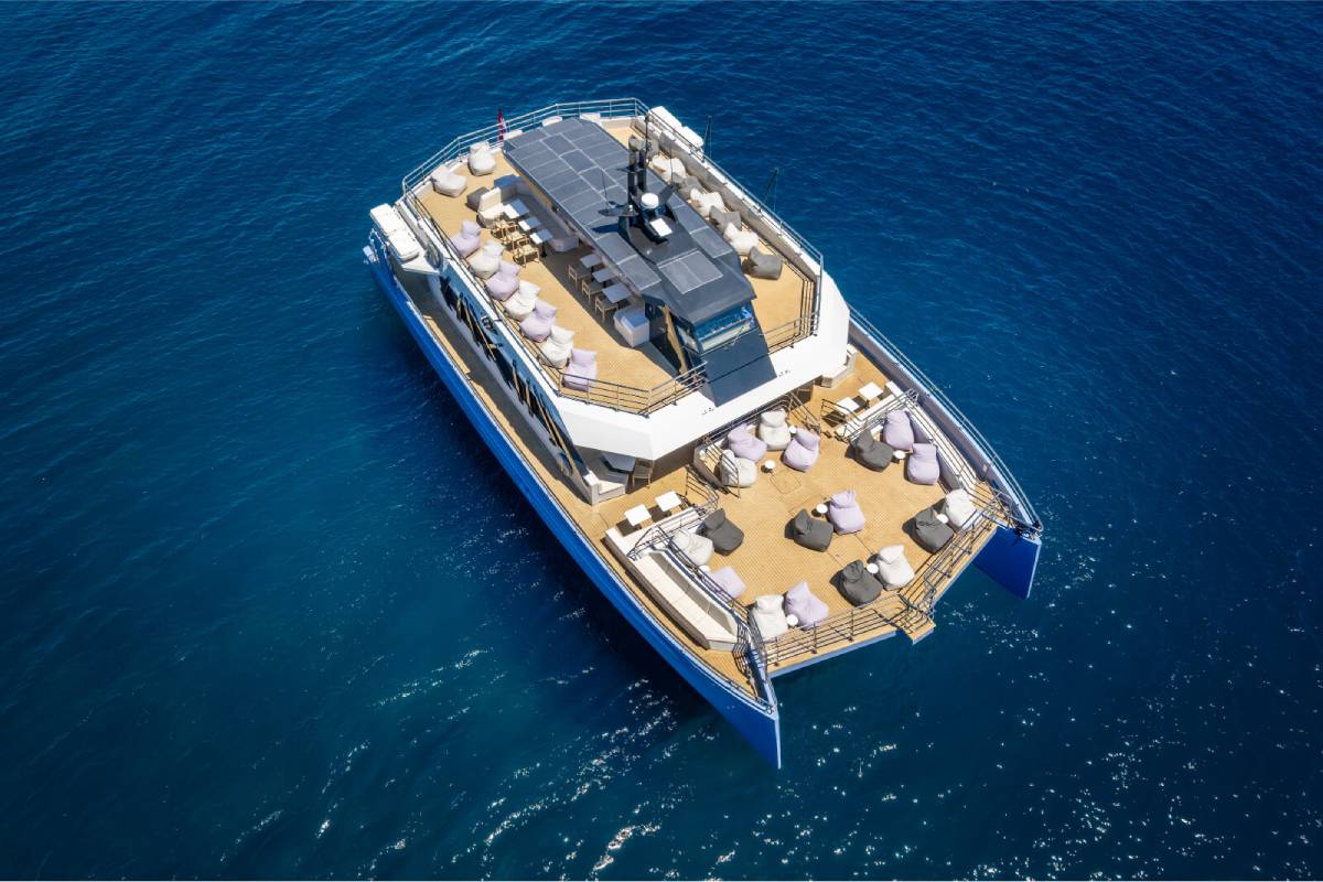 Areal view of a luxury catamaran with spacious outdoor decks at sea