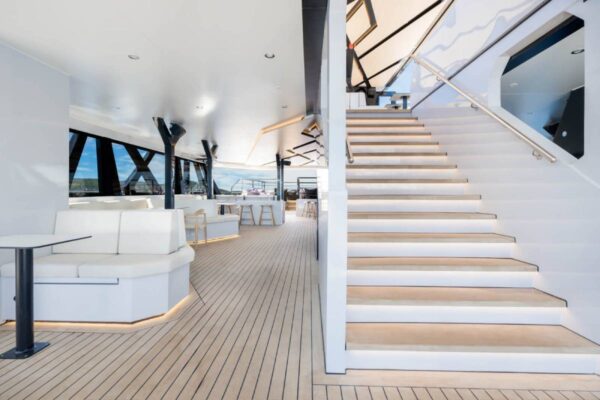 Modern staircase and covered lounge area on a catamaran deck