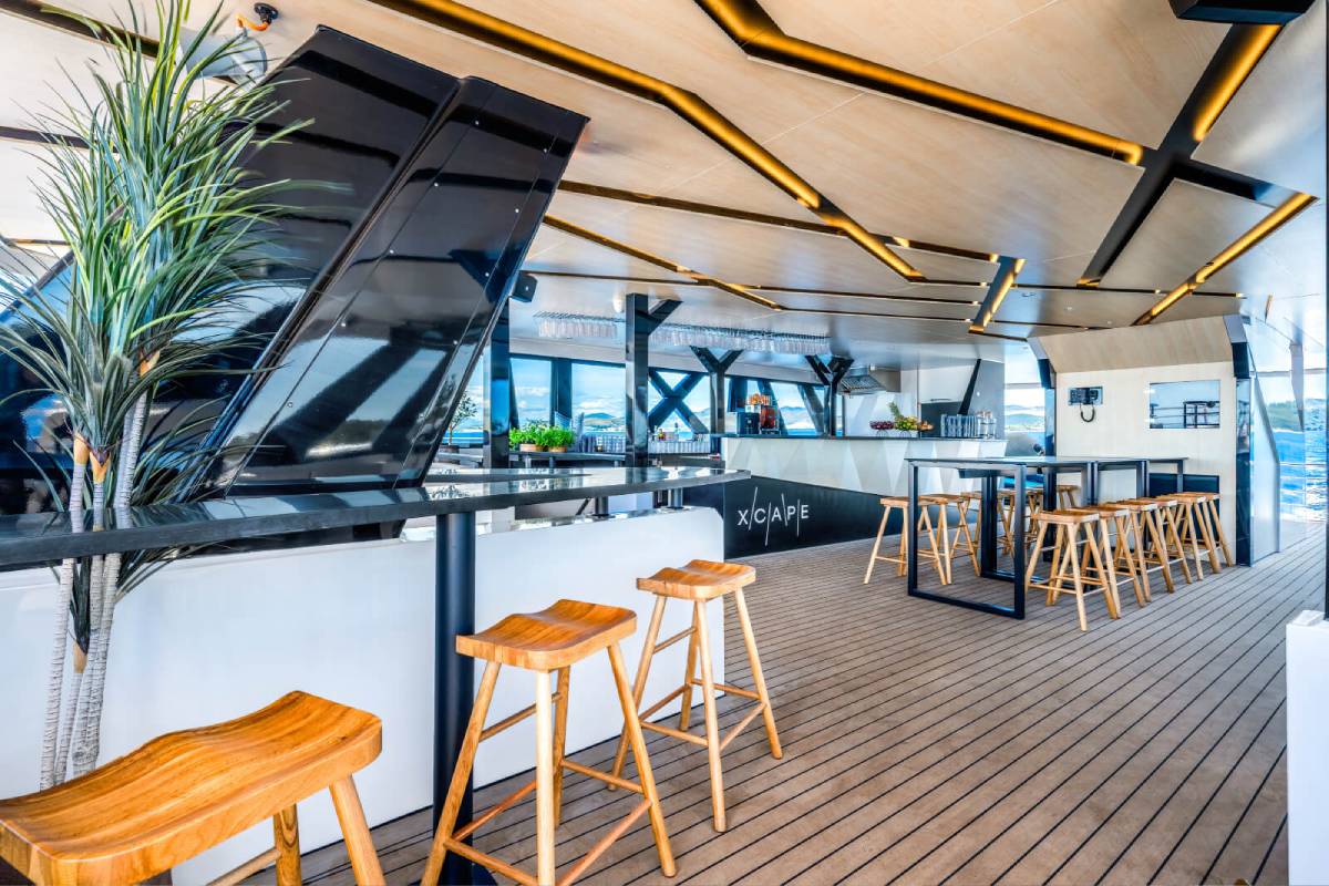 Modern catamaran bar with wooden bar stools