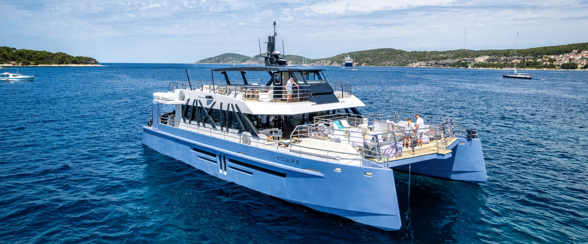 Front view of a luxury catamaran with spacious outdoor decks at sea